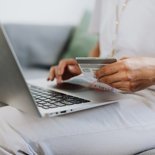 order online credit card and laptop on lap e1606661626492.jpg